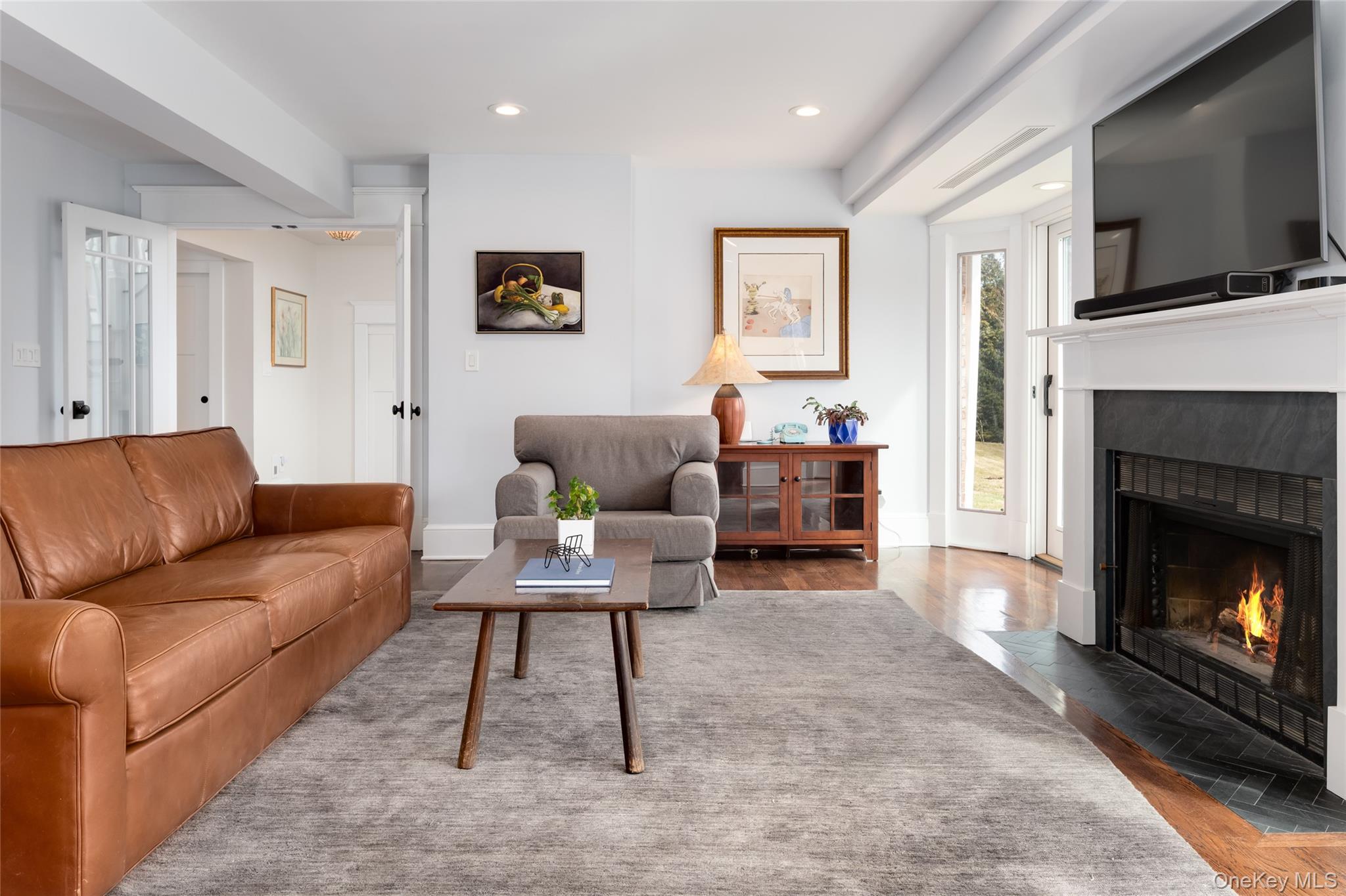 239 Sunny Ridge Road Harrison, NY 10528 - Photo 11 of 33 a living room with furniture a flat screen tv and a fireplace