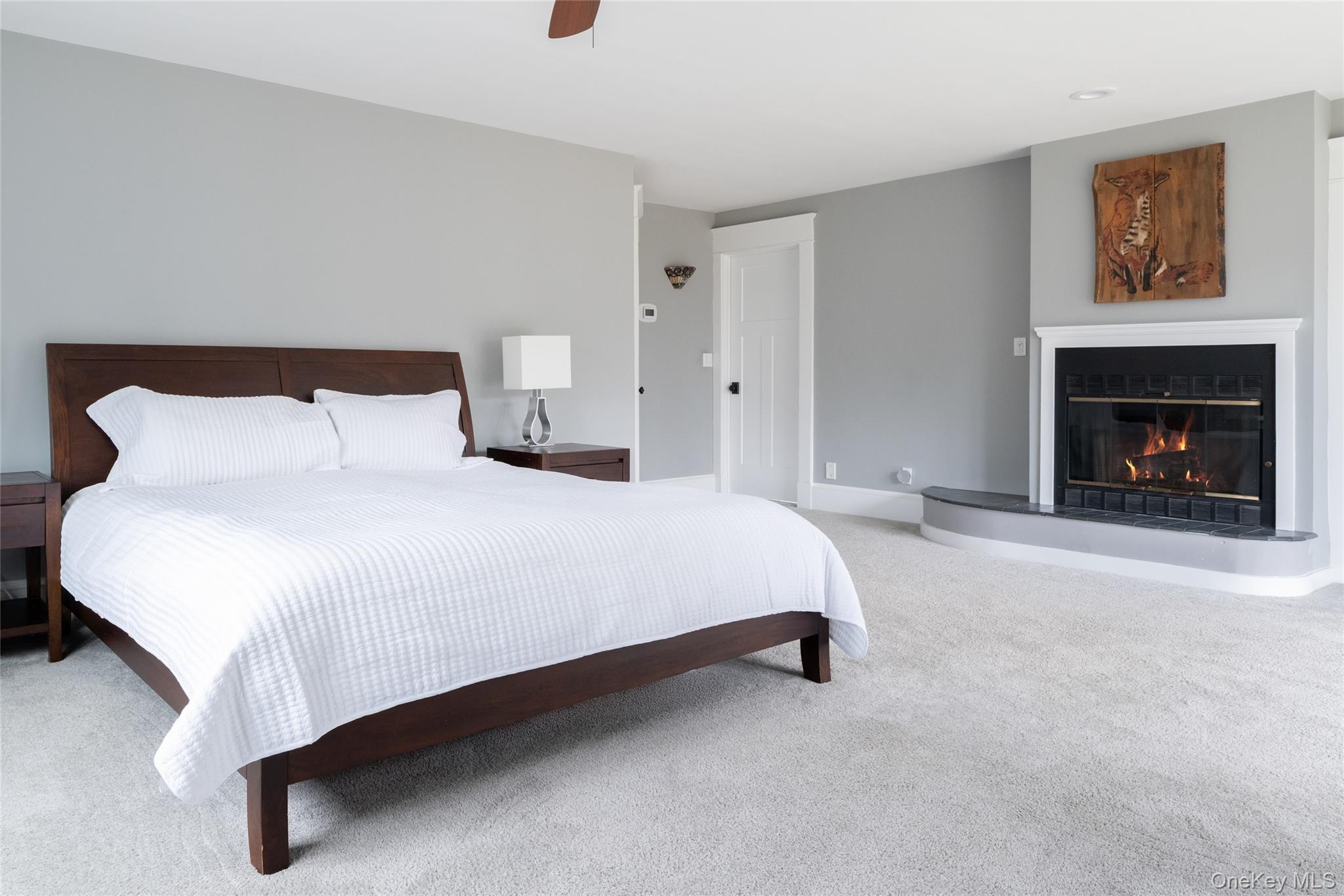 239 Sunny Ridge Road Harrison, NY 10528 - Photo 13 of 33 a bedroom with a bed and a fireplace