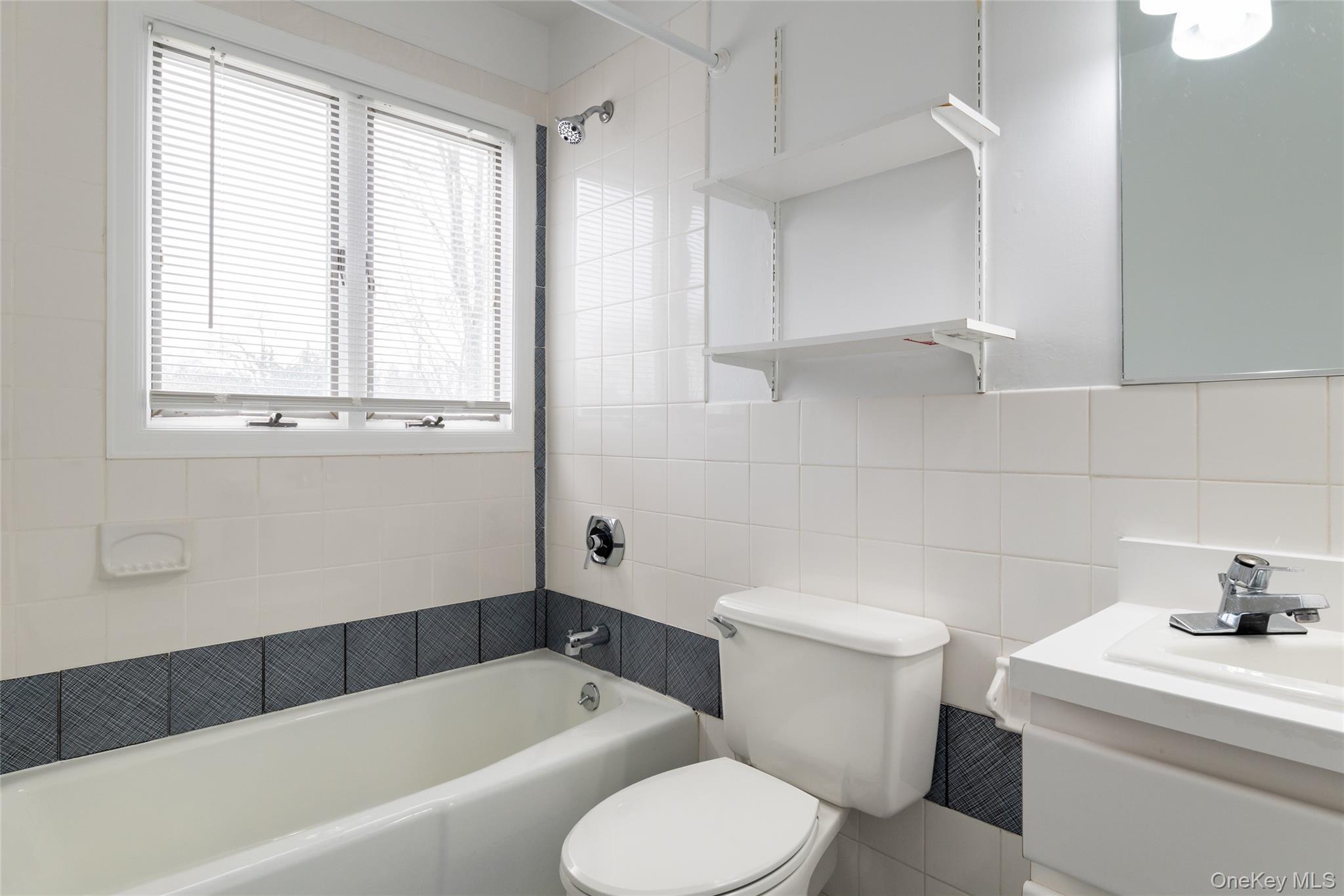 239 Sunny Ridge Road Harrison, NY 10528 - Photo 19 of 33 a bathroom with a sink a toilet and a bathtub