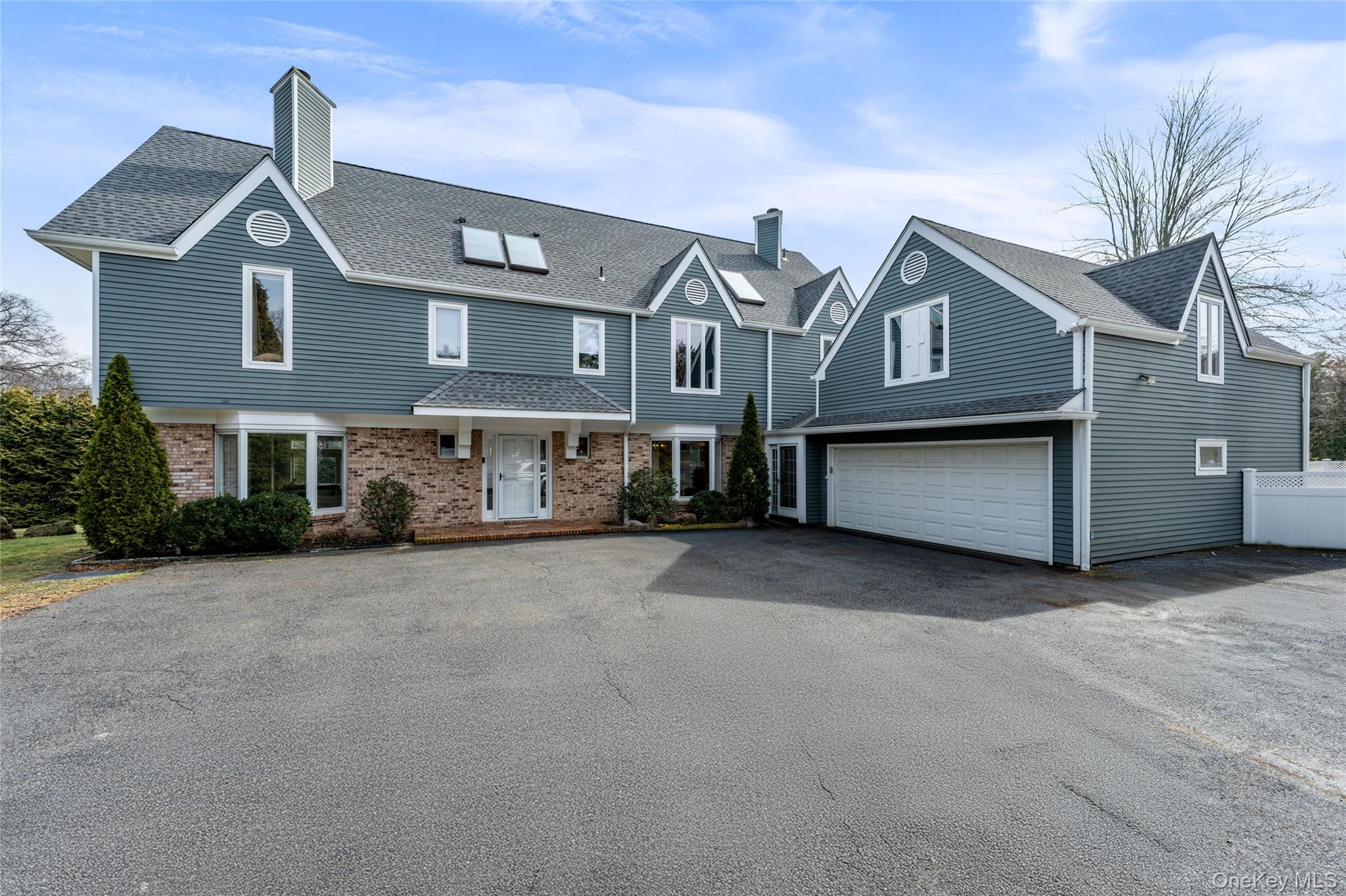 239 Sunny Ridge Road Harrison, NY 10528 - Photo 2 of 33 a front view of a house with a yard and garage