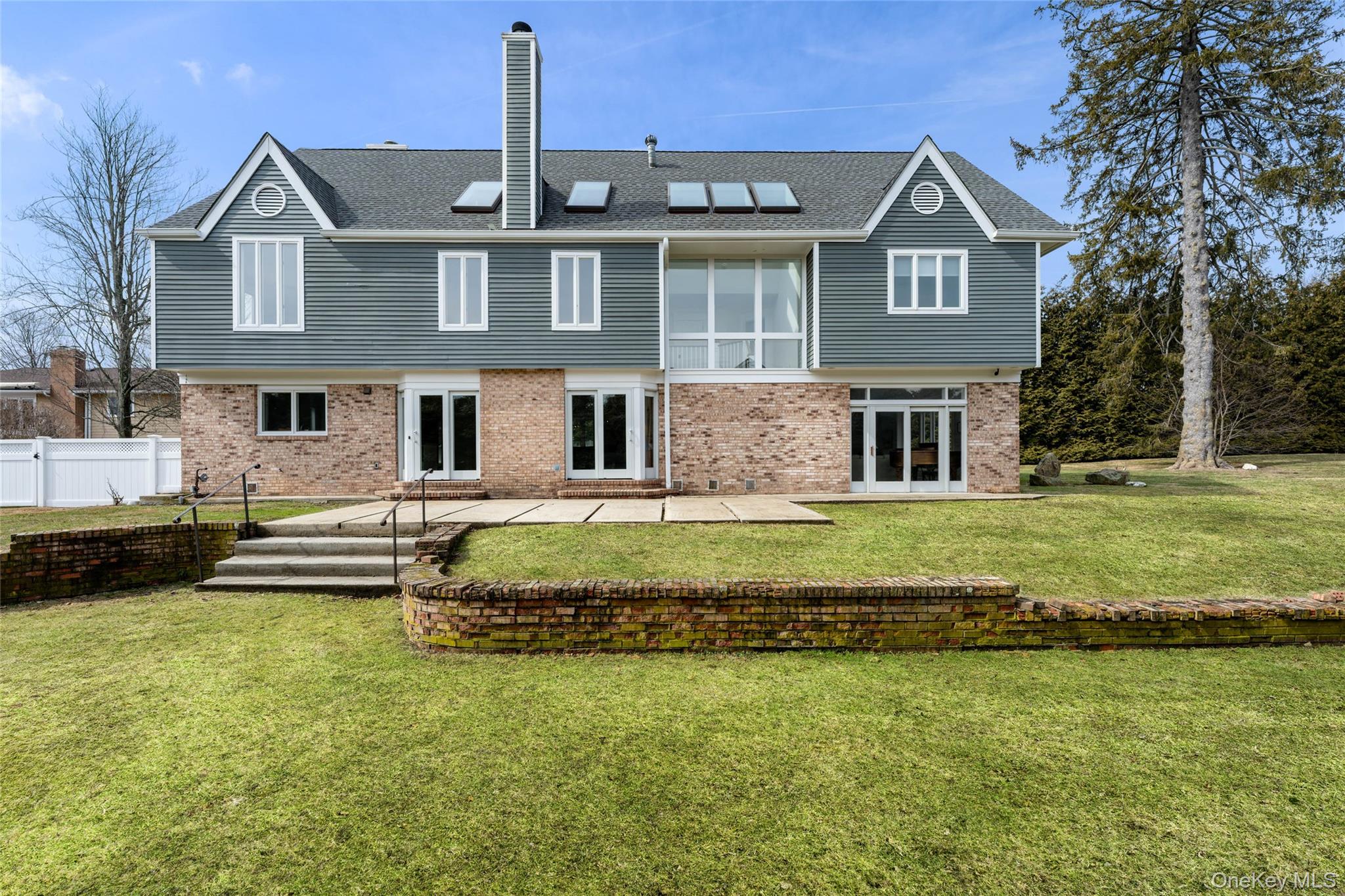 239 Sunny Ridge Road Harrison, NY 10528 - Photo 25 of 33 a front view of a house with a garden