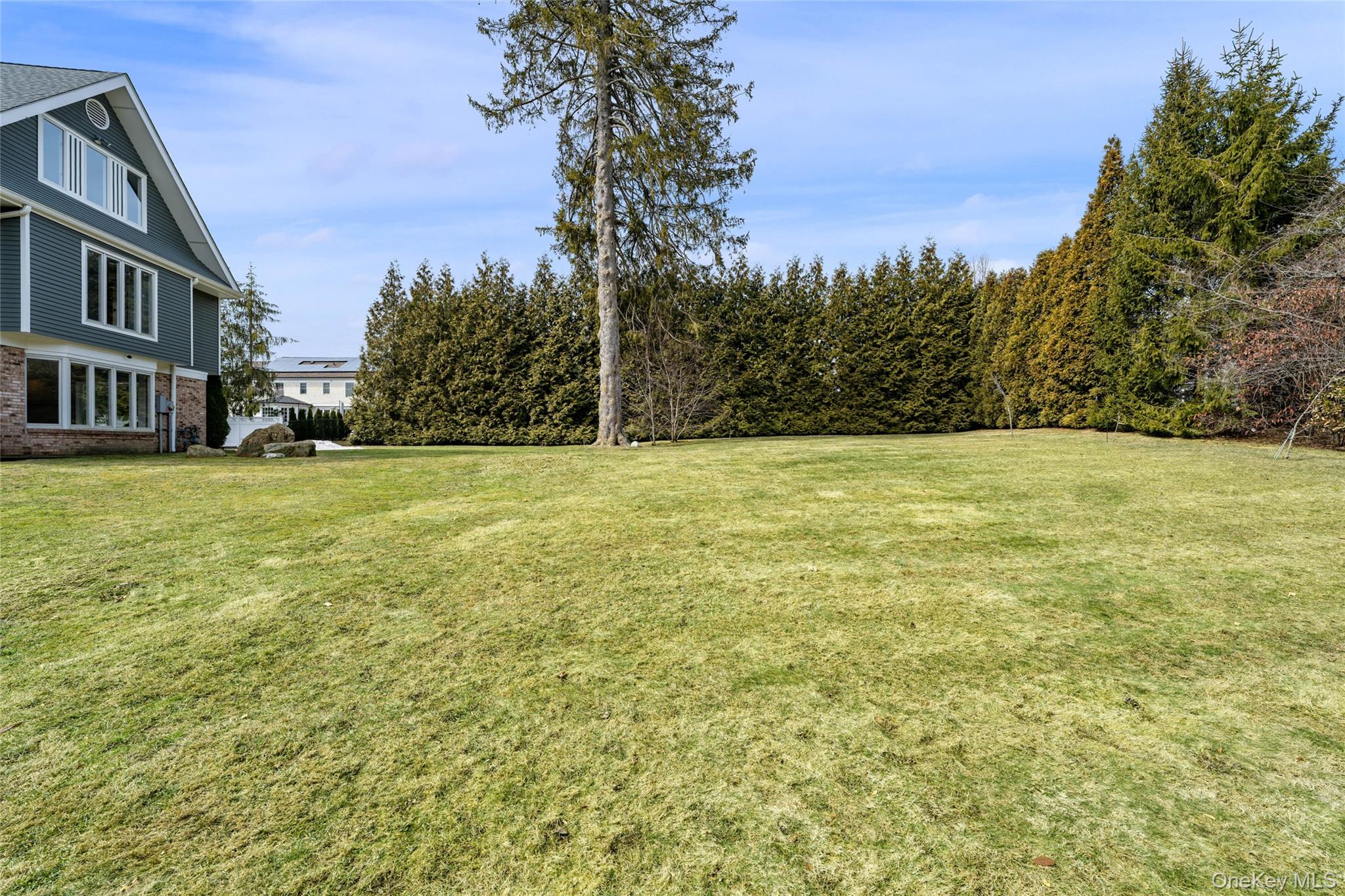 239 Sunny Ridge Road Harrison, NY 10528 - Photo 28 of 33 a view of a field with an trees in front of it