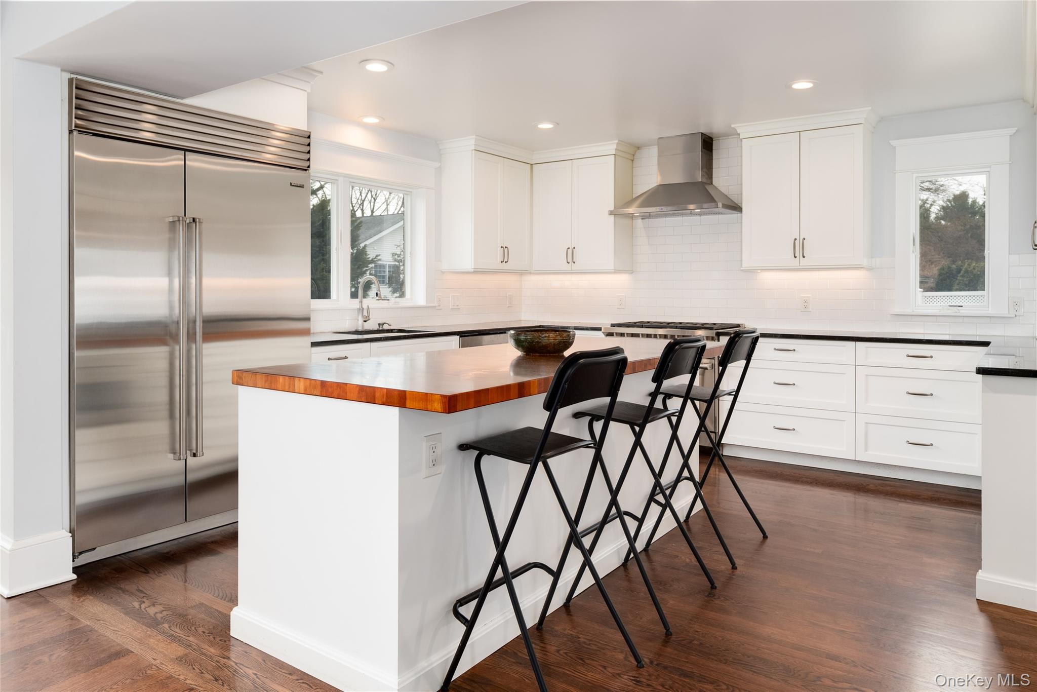 239 Sunny Ridge Road Harrison, NY 10528 - Photo 9 of 33 a kitchen with stainless steel appliances granite countertop a table chairs sink and cabinets