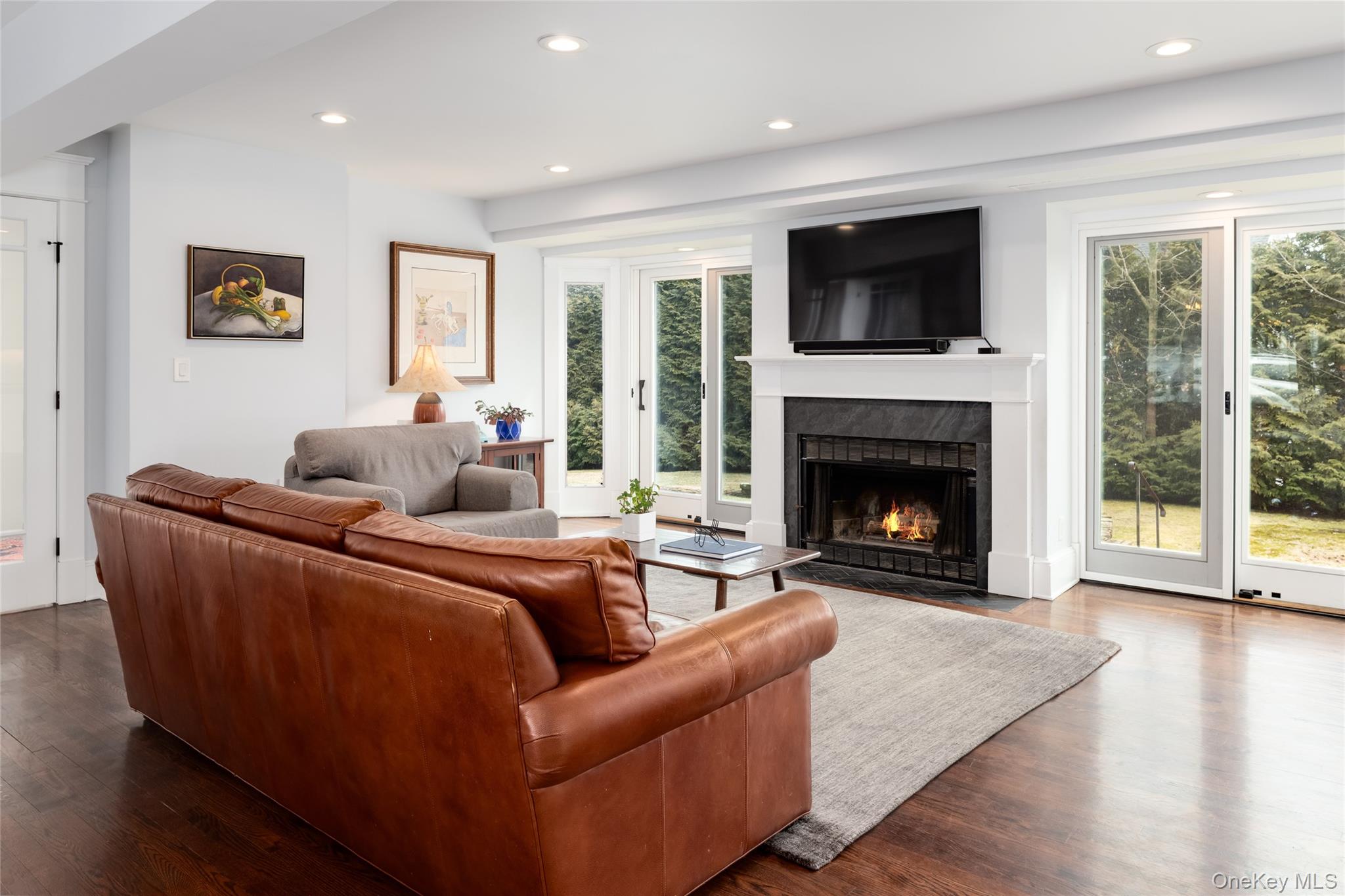 239 Sunny Ridge Road Harrison, NY 10528 - Photo 10 of 33 a living room with furniture a flat screen tv and a fireplace