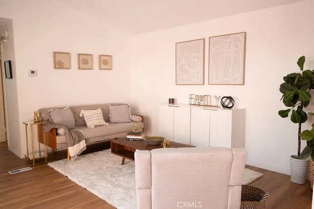 a living room with furniture and a potted plant
