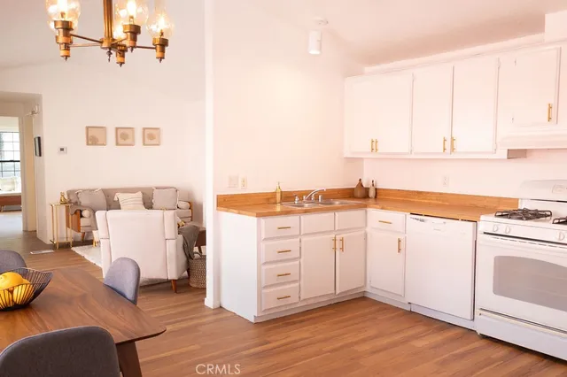 a kitchen with cabinets and wooden floor