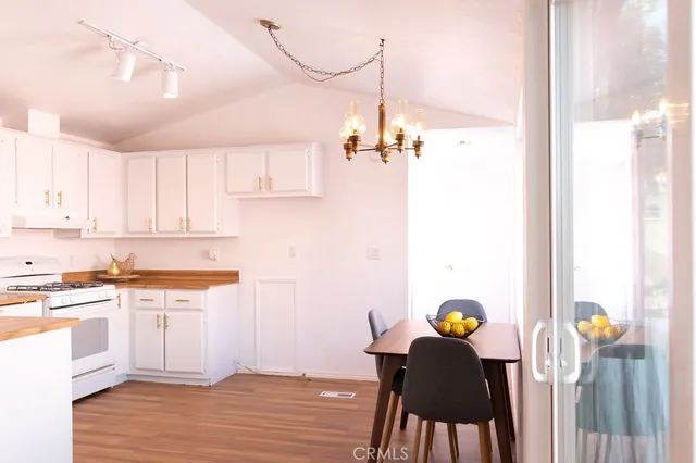 a kitchen with a table chairs and a chandelier