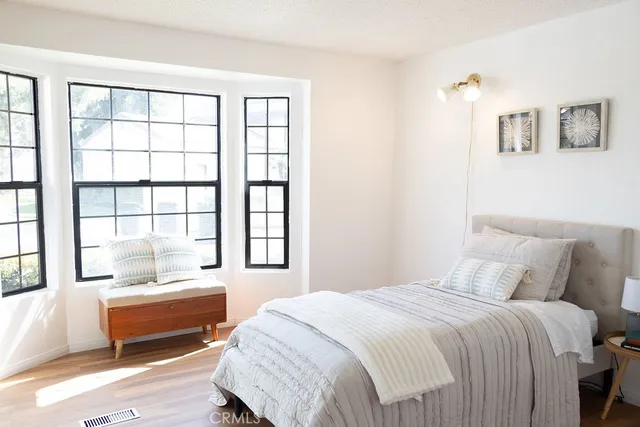 a bedroom with a bed and a large window