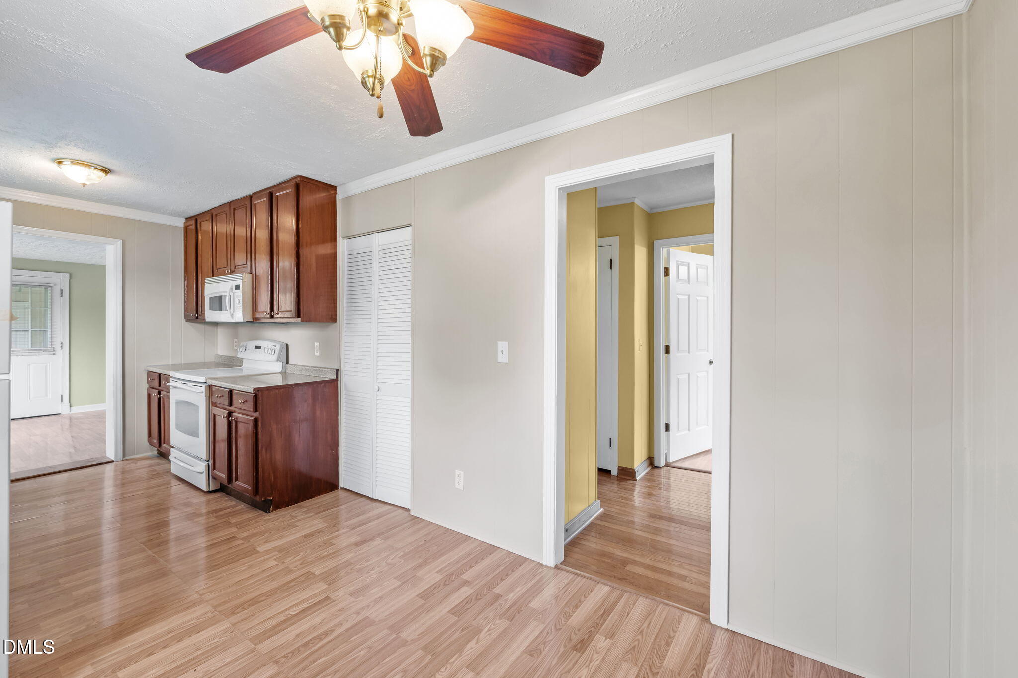 95 Harold Gill Road Roxboro, NC 27574 - Photo 7 of 53 a view of a hallway with wooden floor and a kitchen