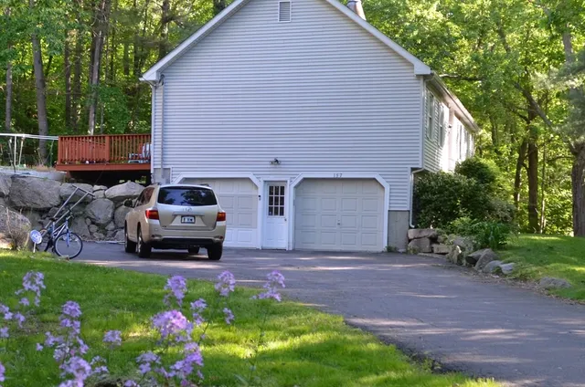 a view of a house with a yard and garage