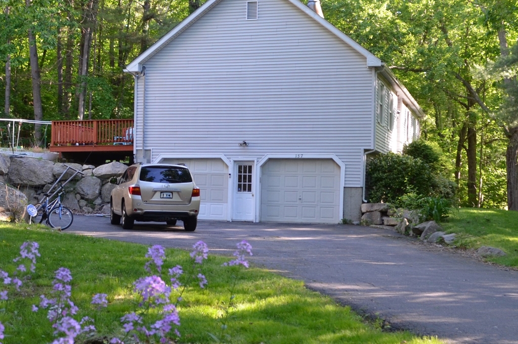 157 Southville Road Southborough, MA 01772 - Photo 1 of 13 a view of a house with a yard and garage