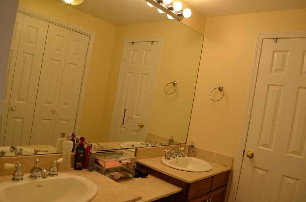 157 Southville Road Southborough, MA 01772 - Photo 11 of 13 a bathroom with a double vanity sink and a mirror