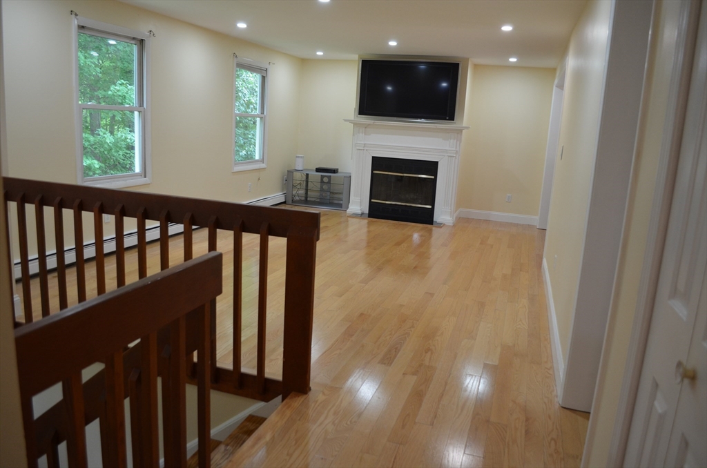 157 Southville Road Southborough, MA 01772 - Photo 3 of 13 a view of dinning room with wooden floor fireplace and windows