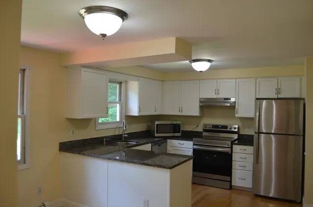 a kitchen with a sink appliances and cabinets