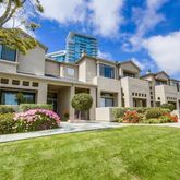 a front view of a building with cars