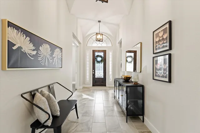 a kitchen with stainless steel appliances granite countertop a sink a stove and a refrigerator