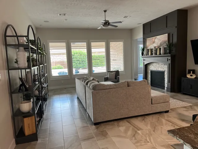 a living room with furniture a flat screen tv and a fireplace