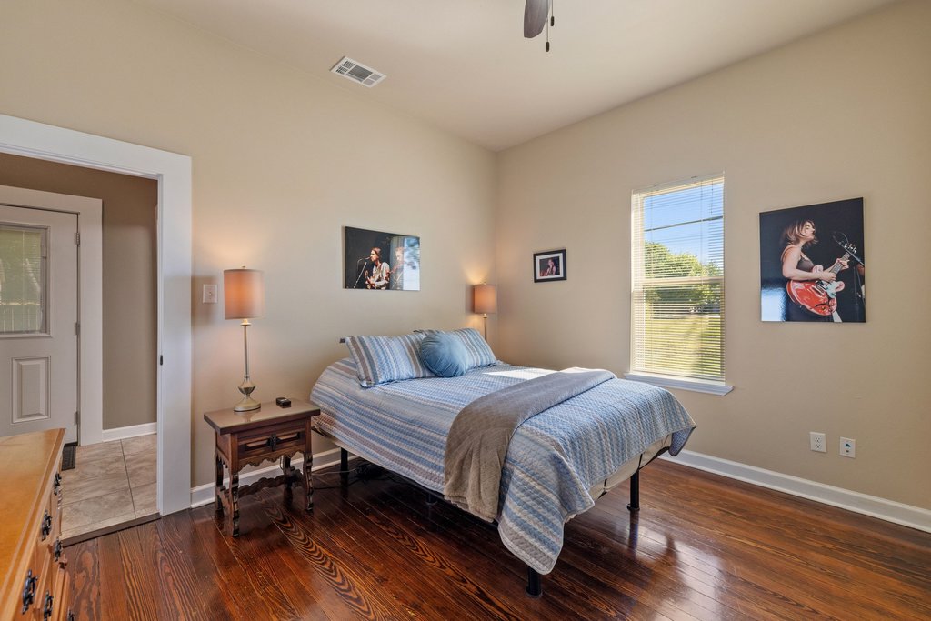 312 West 3rd Street Taylor, TX 76574 - Photo 11 of 33 a bedroom with a bed and a table