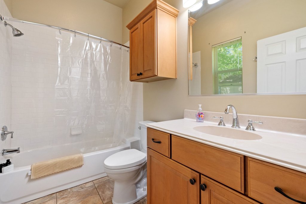312 West 3rd Street Taylor, TX 76574 - Photo 12 of 33 a bathroom with a sink a toilet and shower