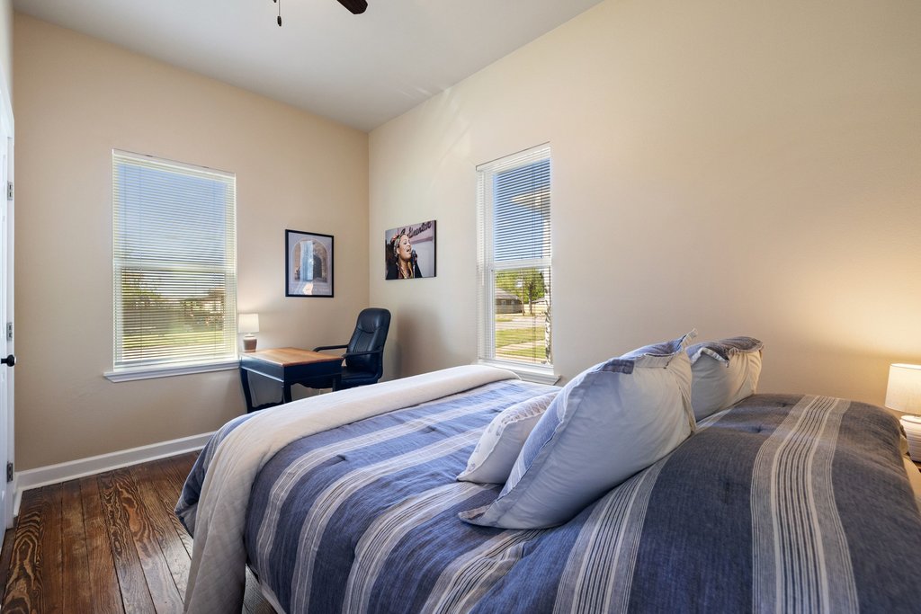 312 West 3rd Street Taylor, TX 76574 - Photo 13 of 33 a bedroom with a bed and a window