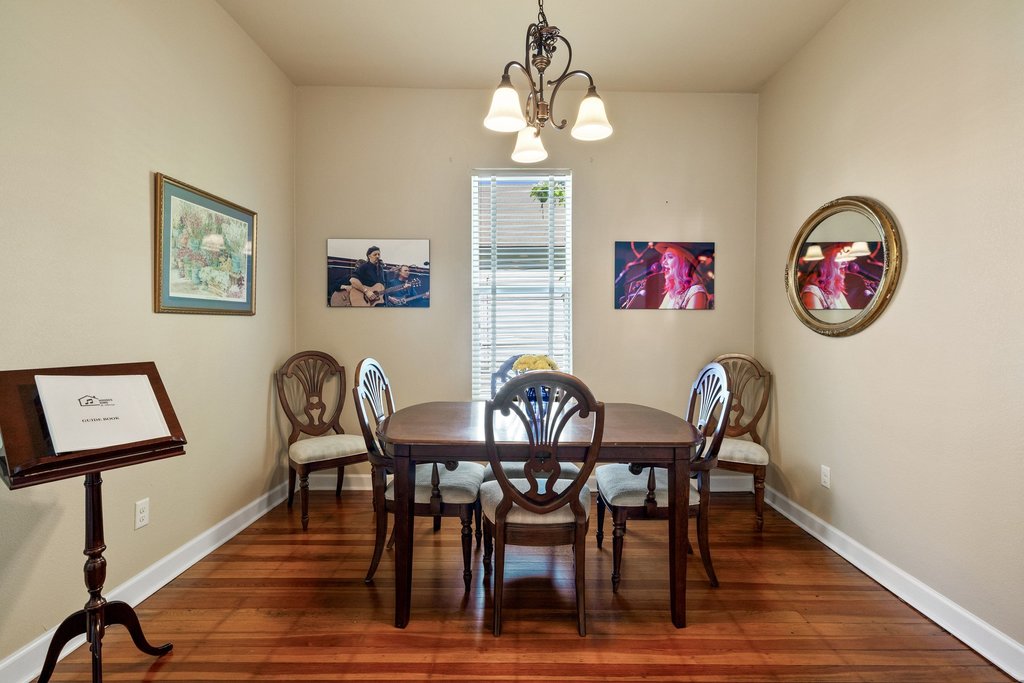312 West 3rd Street Taylor, TX 76574 - Photo 22 of 33 a view of a dining room with furniture and wooden floor