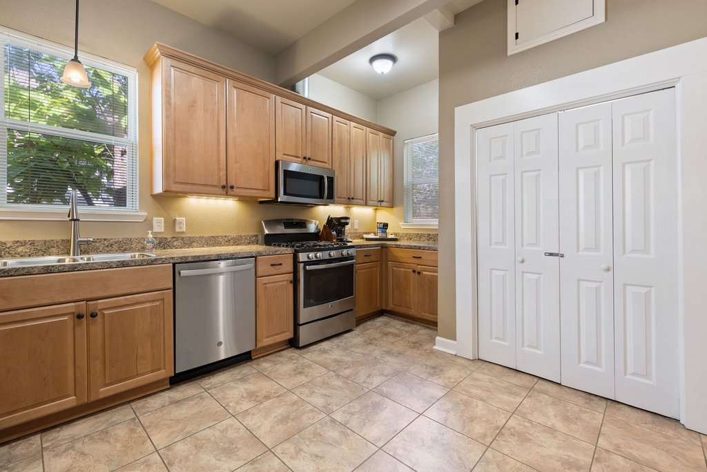 312 West 3rd Street Taylor, TX 76574 - Photo 23 of 33 a kitchen with a sink stove and microwave