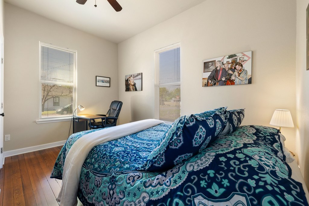 312 West 3rd Street Taylor, TX 76574 - Photo 28 of 33 a bed sitting in a bedroom next to a window