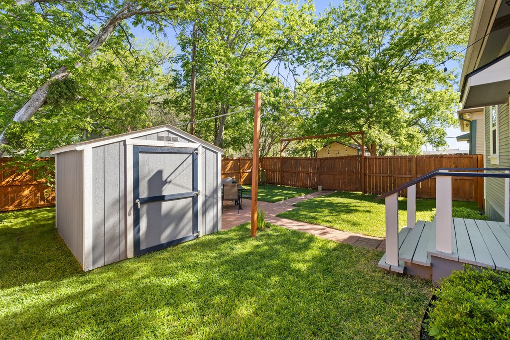 312 West 3rd Street Taylor, TX 76574 - Photo 31 of 33 a view of backyard with wooden fence and a large tree