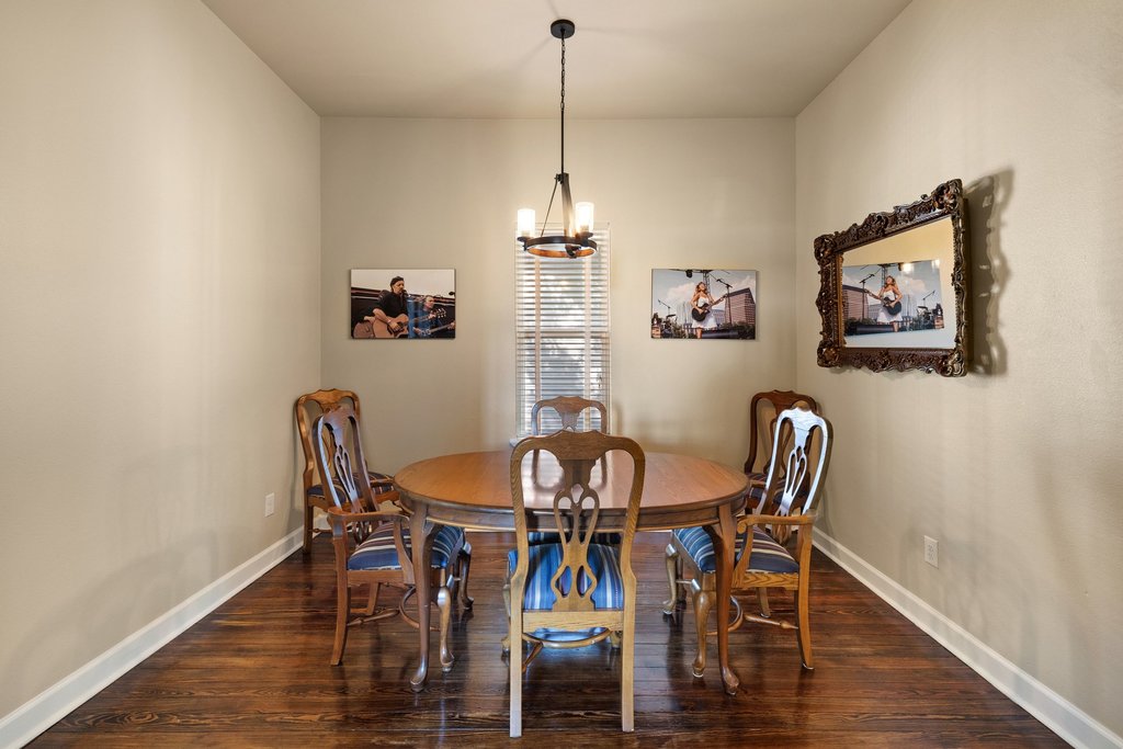 312 West 3rd Street Taylor, TX 76574 - Photo 7 of 33 a view of a dining room with furniture wooden floor and chandelier