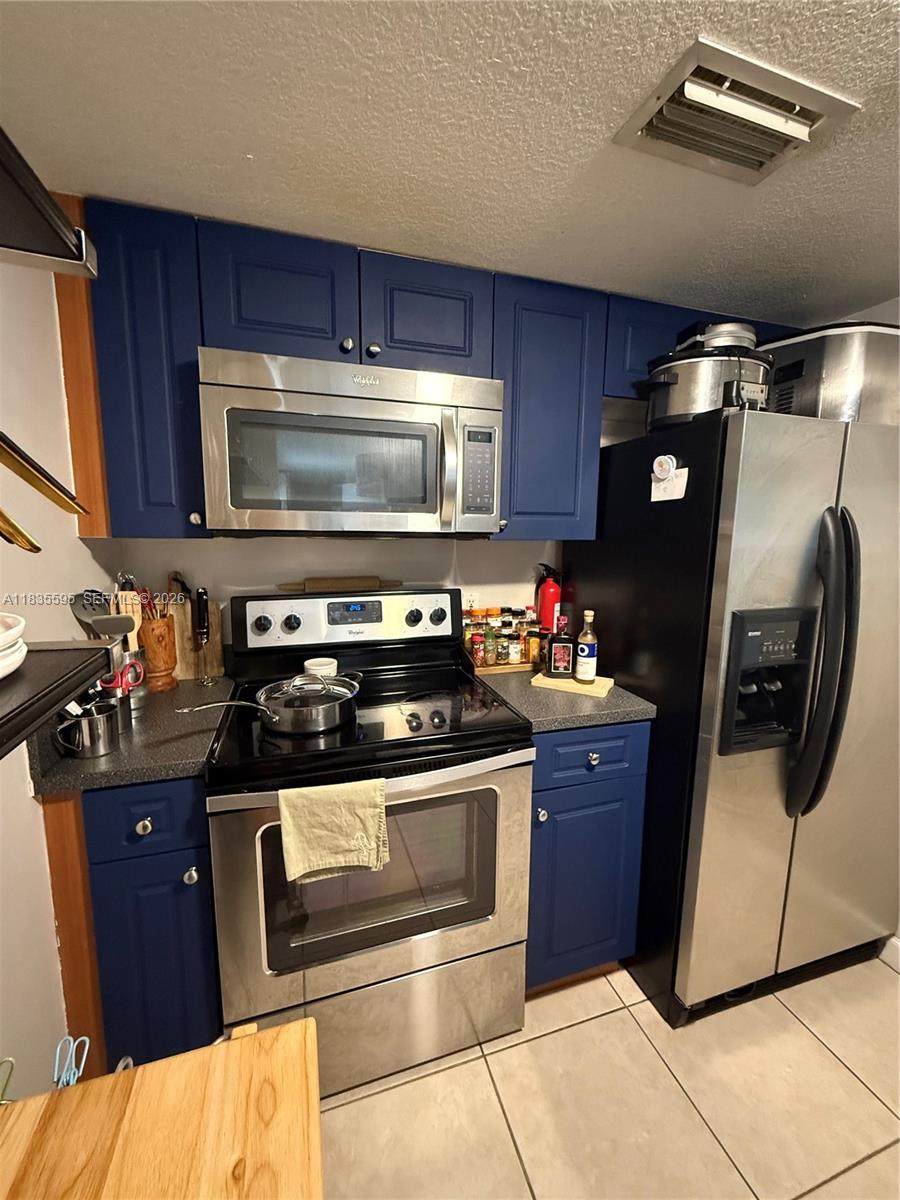 280 Southwest 20th Road, Unit 404 Miami, FL 33129 - Photo 14 of 19 a kitchen with stainless steel appliances granite countertop a stove and a microwave