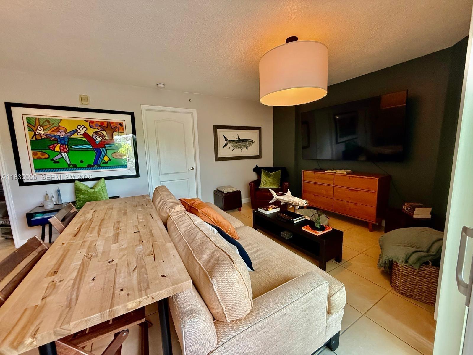 280 Southwest 20th Road, Unit 404 Miami, FL 33129 - Photo 15 of 19 a bed room with a bed mirror and a flat screen tv