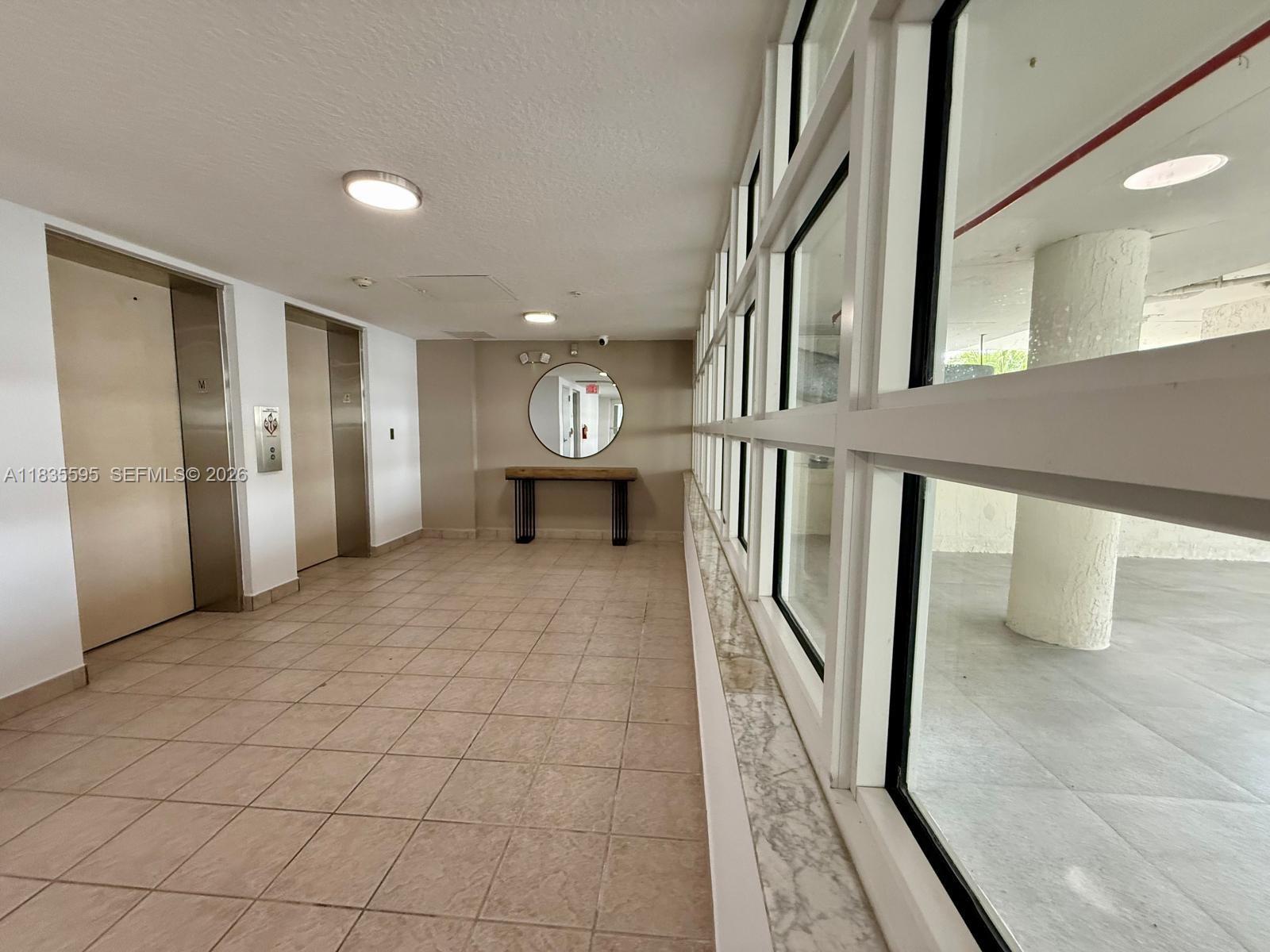 280 Southwest 20th Road, Unit 404 Miami, FL 33129 - Photo 4 of 19 a view of an empty room with wooden floor and a window