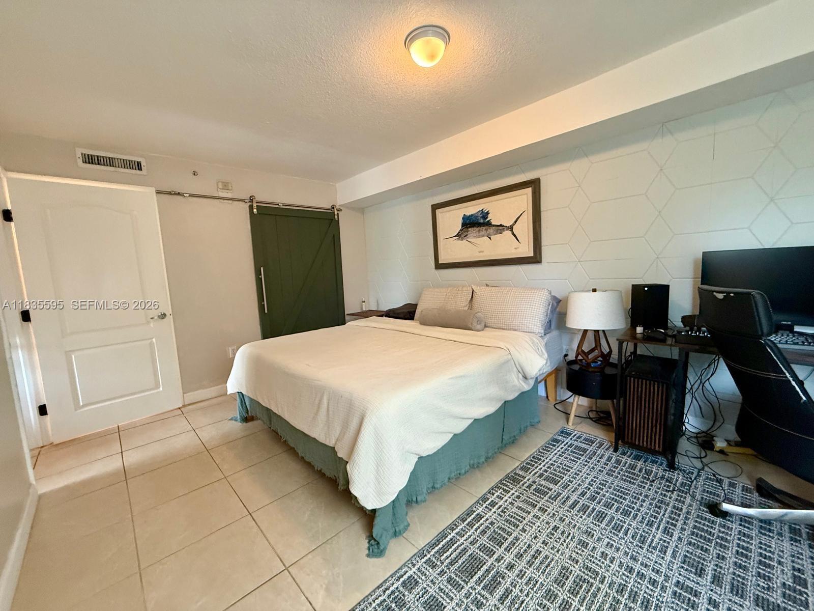 280 Southwest 20th Road, Unit 404 Miami, FL 33129 - Photo 5 of 19 a bedroom with a bed and wooden floor