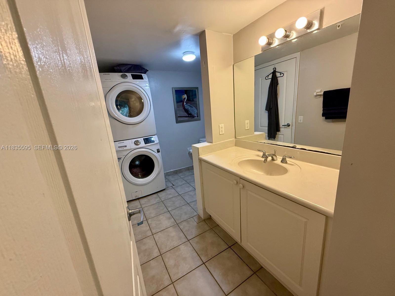 280 Southwest 20th Road, Unit 404 Miami, FL 33129 - Photo 9 of 19 a bathroom with a sink mirror and washing machine