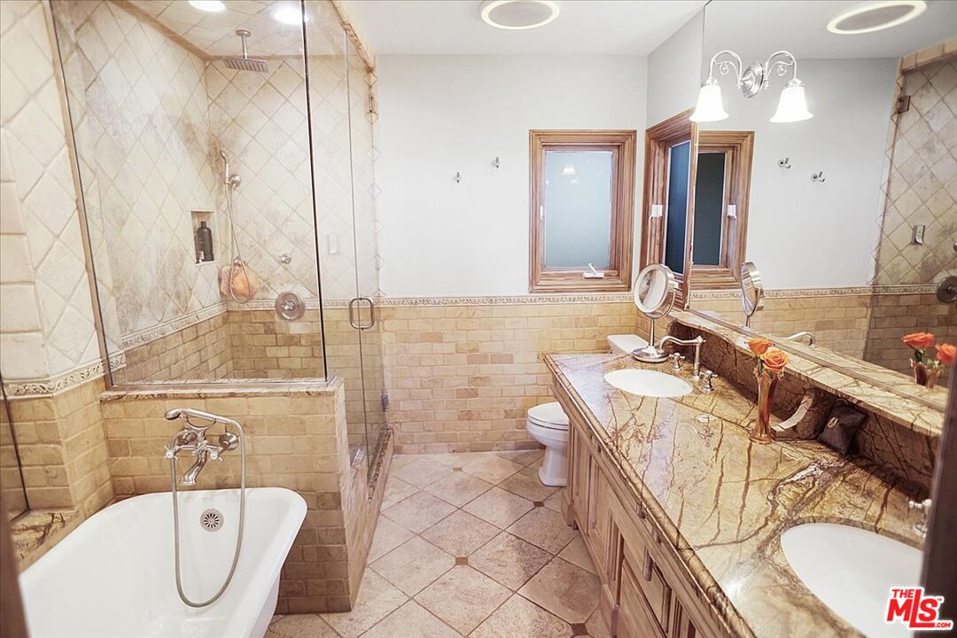2270 Stradella Road Los Angeles, CA 90077 - Photo 14 of 29 a bathroom with a tub sink and mirror