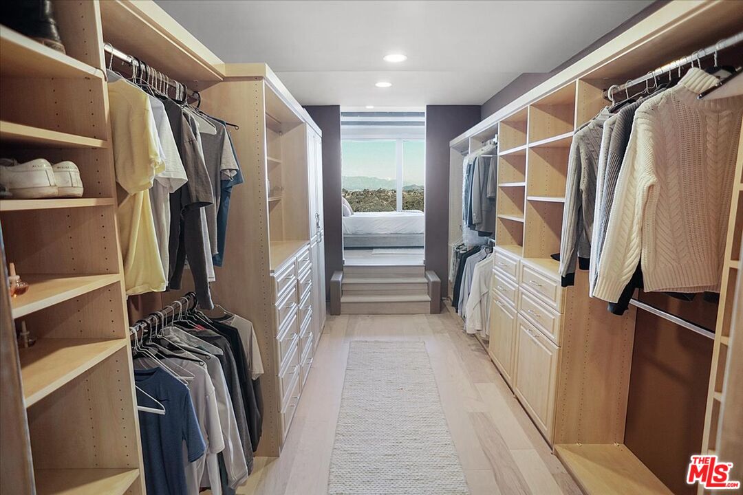 2270 Stradella Road Los Angeles, CA 90077 - Photo 15 of 29 a view of walk in closet with clothes and shoes
