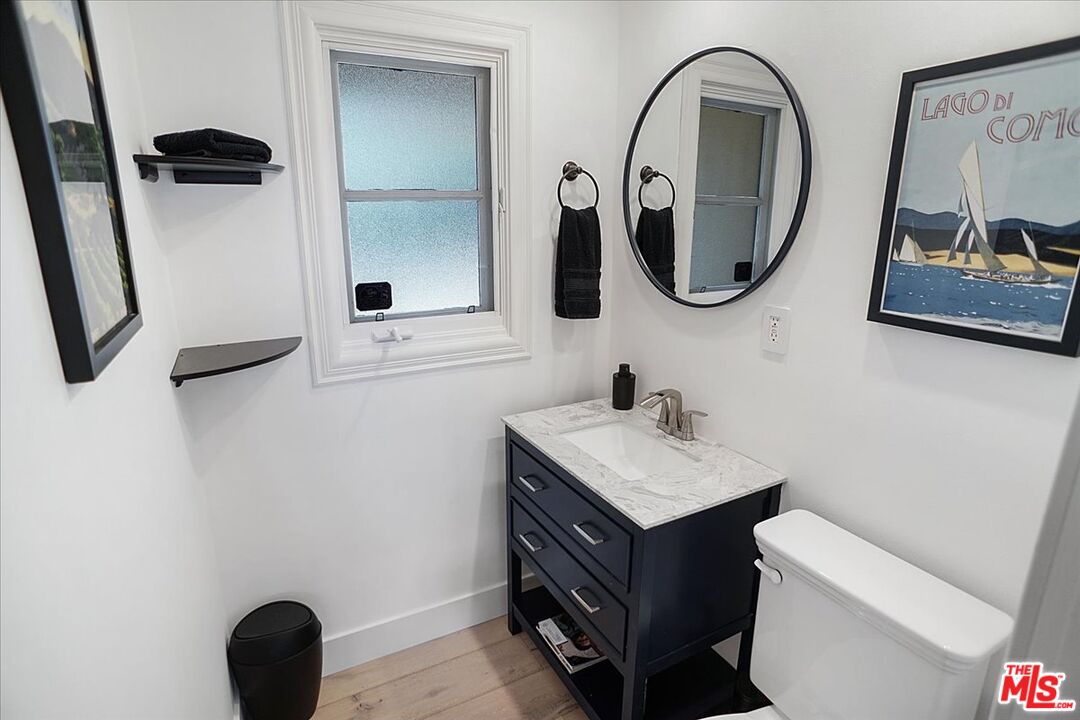 2270 Stradella Road Los Angeles, CA 90077 - Photo 18 of 29 a bathroom with a toilet sink vanity and mirror