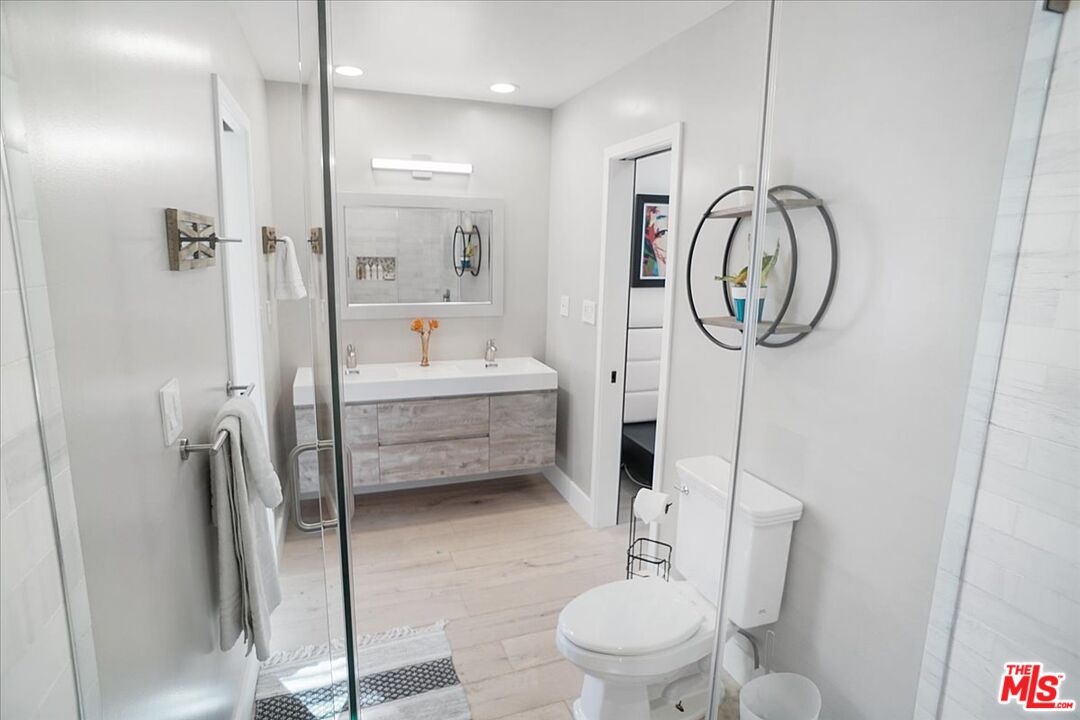 2270 Stradella Road Los Angeles, CA 90077 - Photo 21 of 29 a bathroom with a toilet a sink and a shower