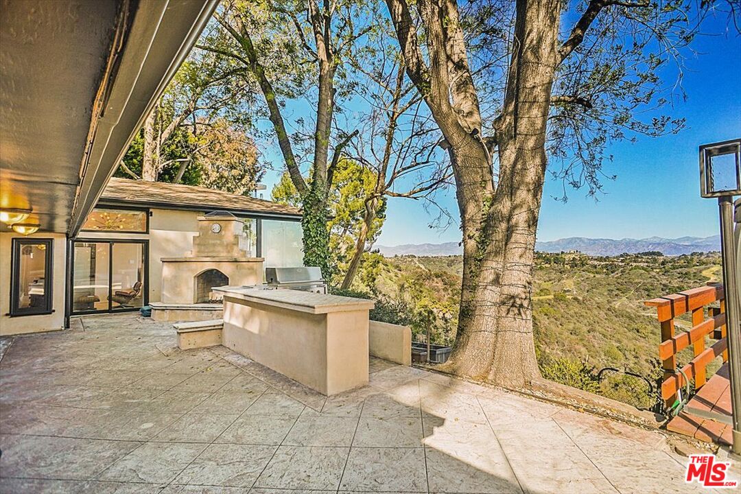 2270 Stradella Road Los Angeles, CA 90077 - Photo 26 of 29 a living room with large trees