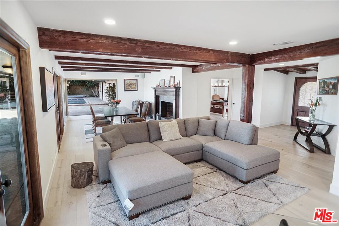 2270 Stradella Road Los Angeles, CA 90077 - Photo 4 of 29 a living room with furniture and a chandelier