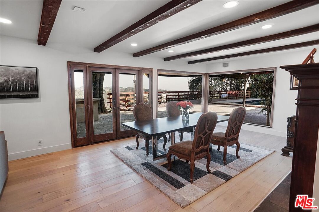 2270 Stradella Road Los Angeles, CA 90077 - Photo 5 of 29 a view of a dining room with furniture window and wooden floor