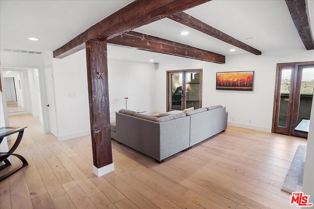 2270 Stradella Road Los Angeles, CA 90077 - Photo 6 of 29 a living room with furniture and a flat screen tv