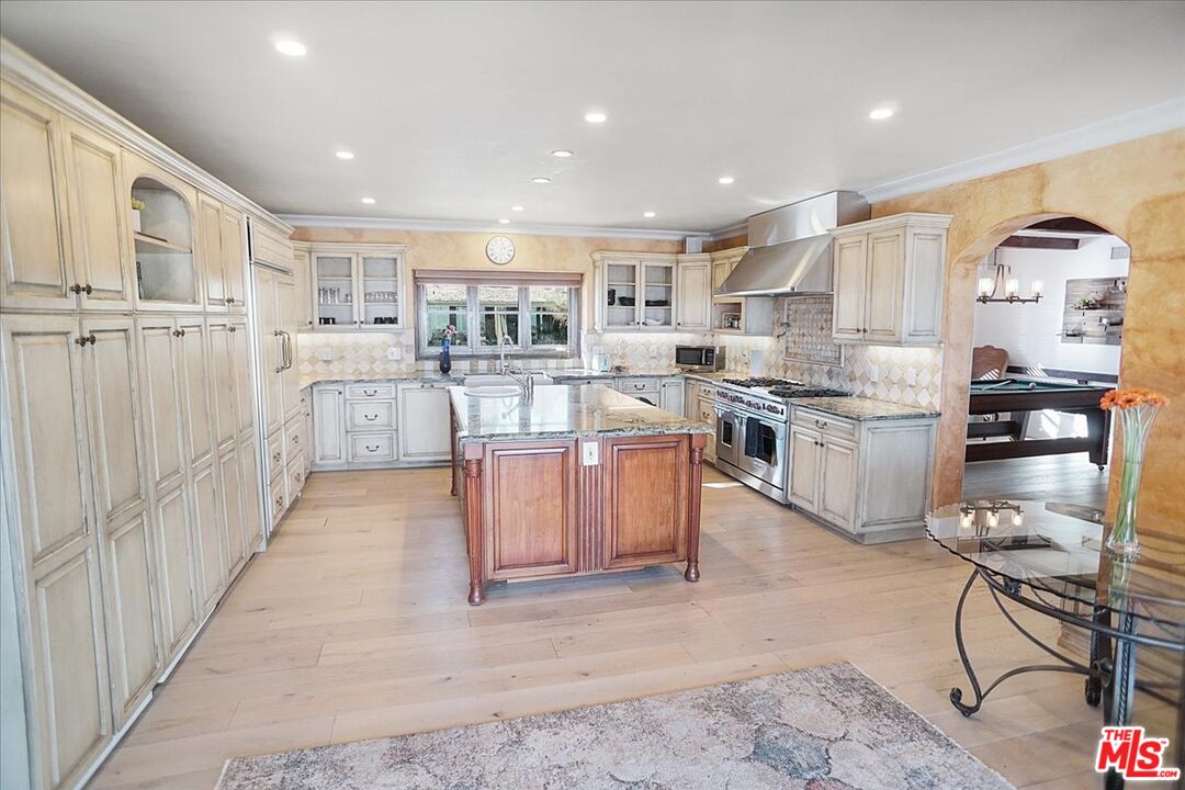 2270 Stradella Road Los Angeles, CA 90077 - Photo 7 of 29 a kitchen with stainless steel appliances kitchen island granite countertop lots of counter top space and cabinets