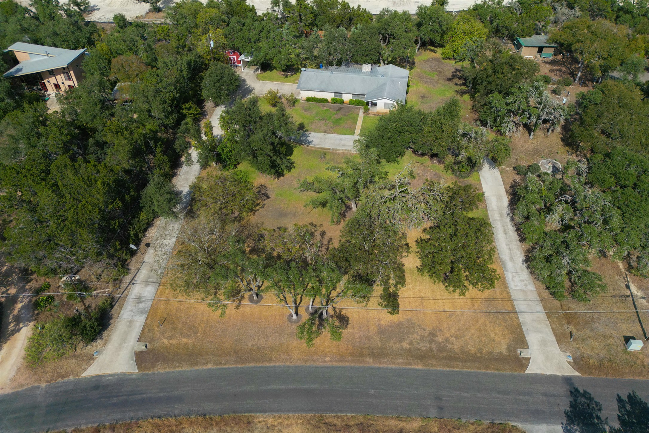 an aerial view of residential houses with yard