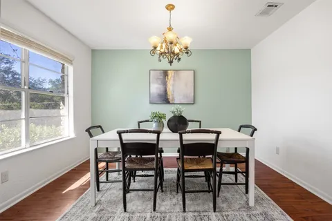 a view of a dining room with furniture and a chandelier