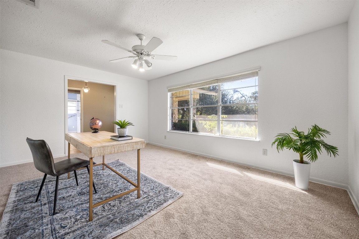 9504 Flintrock Circle Austin, TX 78737 - Photo 16 of 31 a view of a workspace with furniture and a potted plant