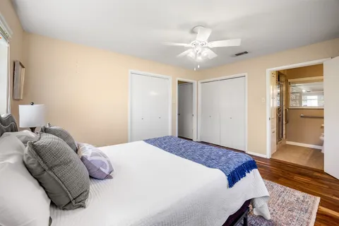 a bedroom with a large bed and a chandelier