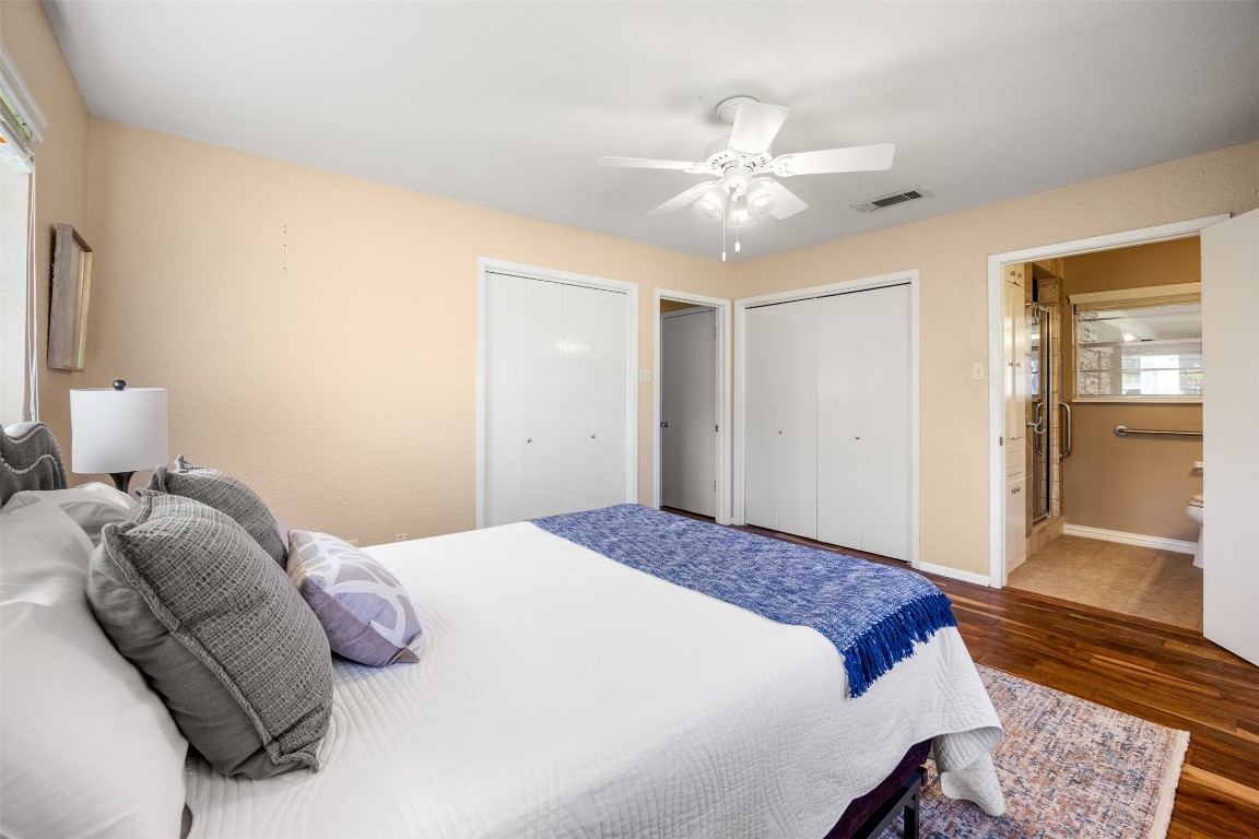 9504 Flintrock Circle Austin, TX 78737 - Photo 18 of 31 a bedroom with a large bed and a chandelier