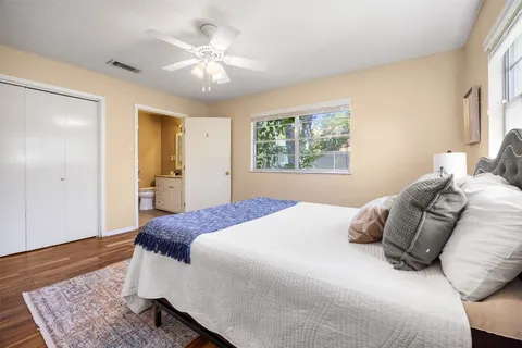 a bedroom with a large bed and a chandelier