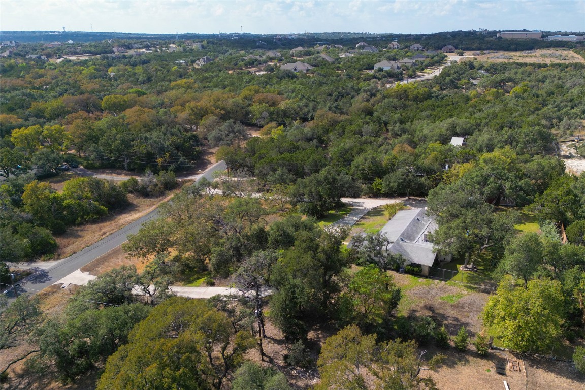 9504 Flintrock Circle Austin, TX 78737 - Photo 24 of 31 an aerial view of residential houses with outdoor space and trees